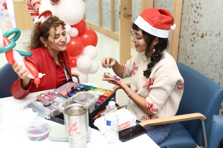 Two women uncapping face paint