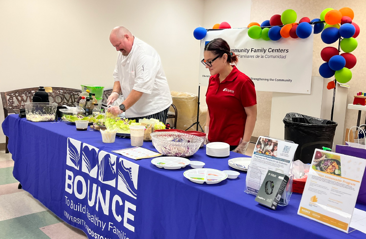 A chef and intern preparing healthy food for the Houston Community