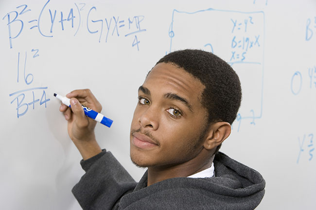 Student doing math at a whiteboard