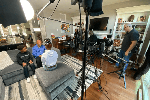 A black man and a black boy being interviewed for a documentary