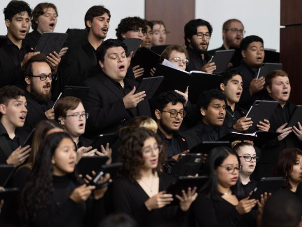 The UH Concert Chorale singing in a concert in the Moores Opera House lobby