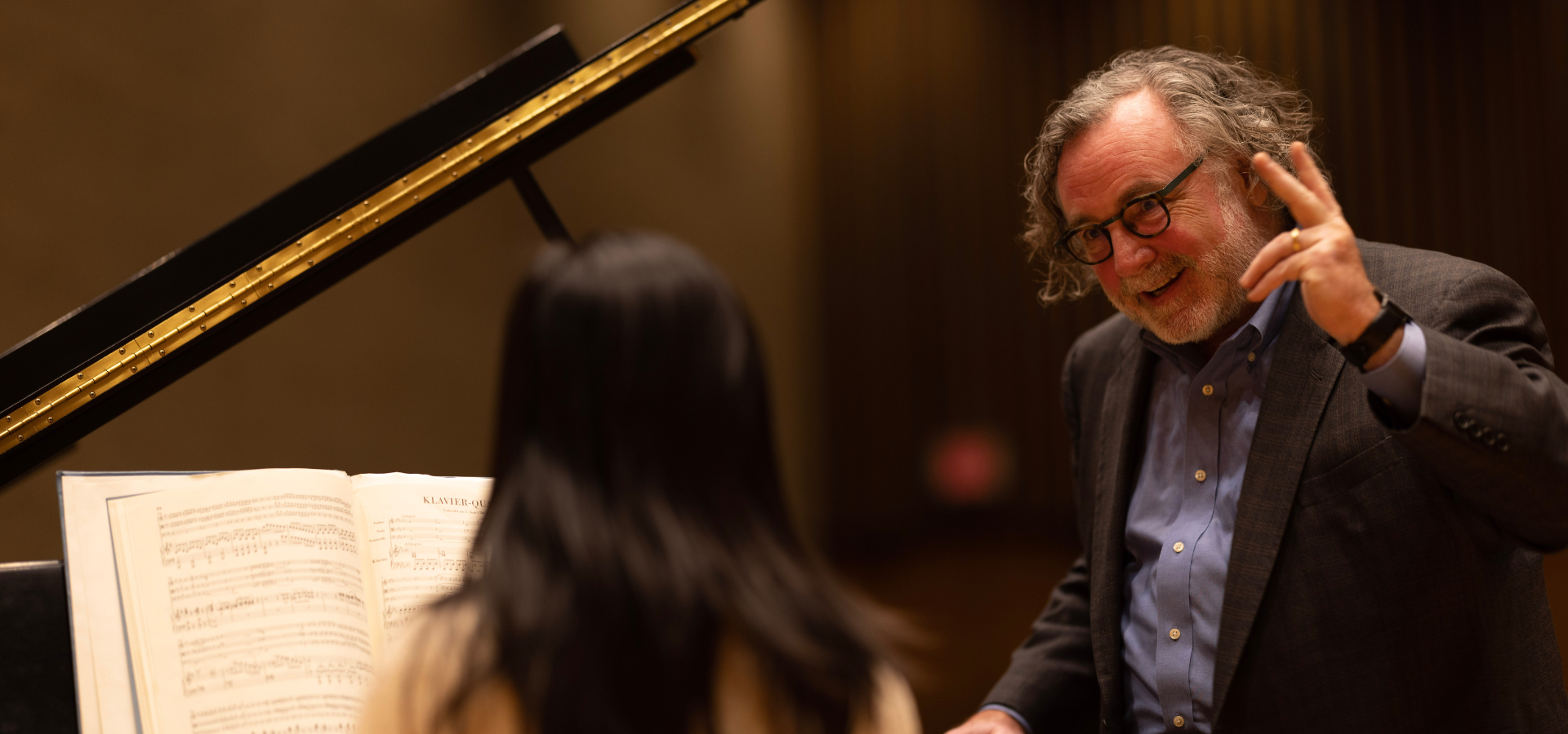 Piano teacher, Timothy Hester, smiling in a piano masterclass