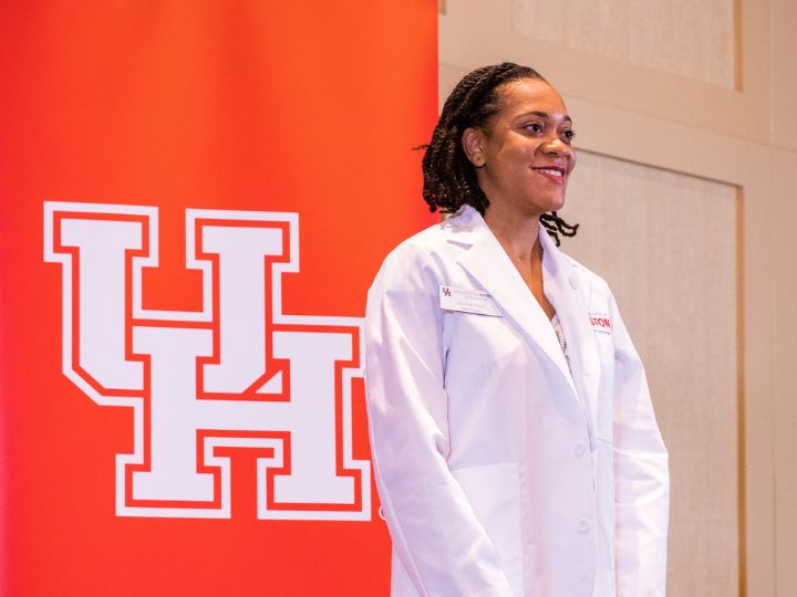 UH Tilman J. Fertitta Family College of Medicine student in white coat.