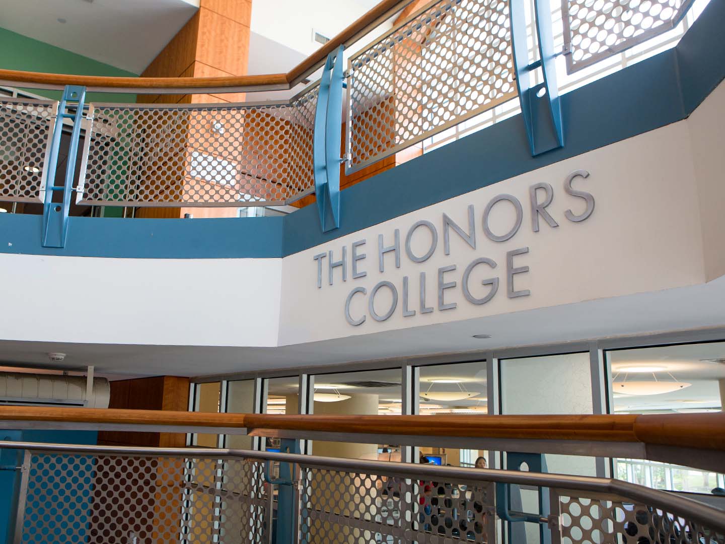 Interior view of a staircase in MD Anderson Library at the University of Houston featuring a sign that reads "THE HONORS COLLEGE."