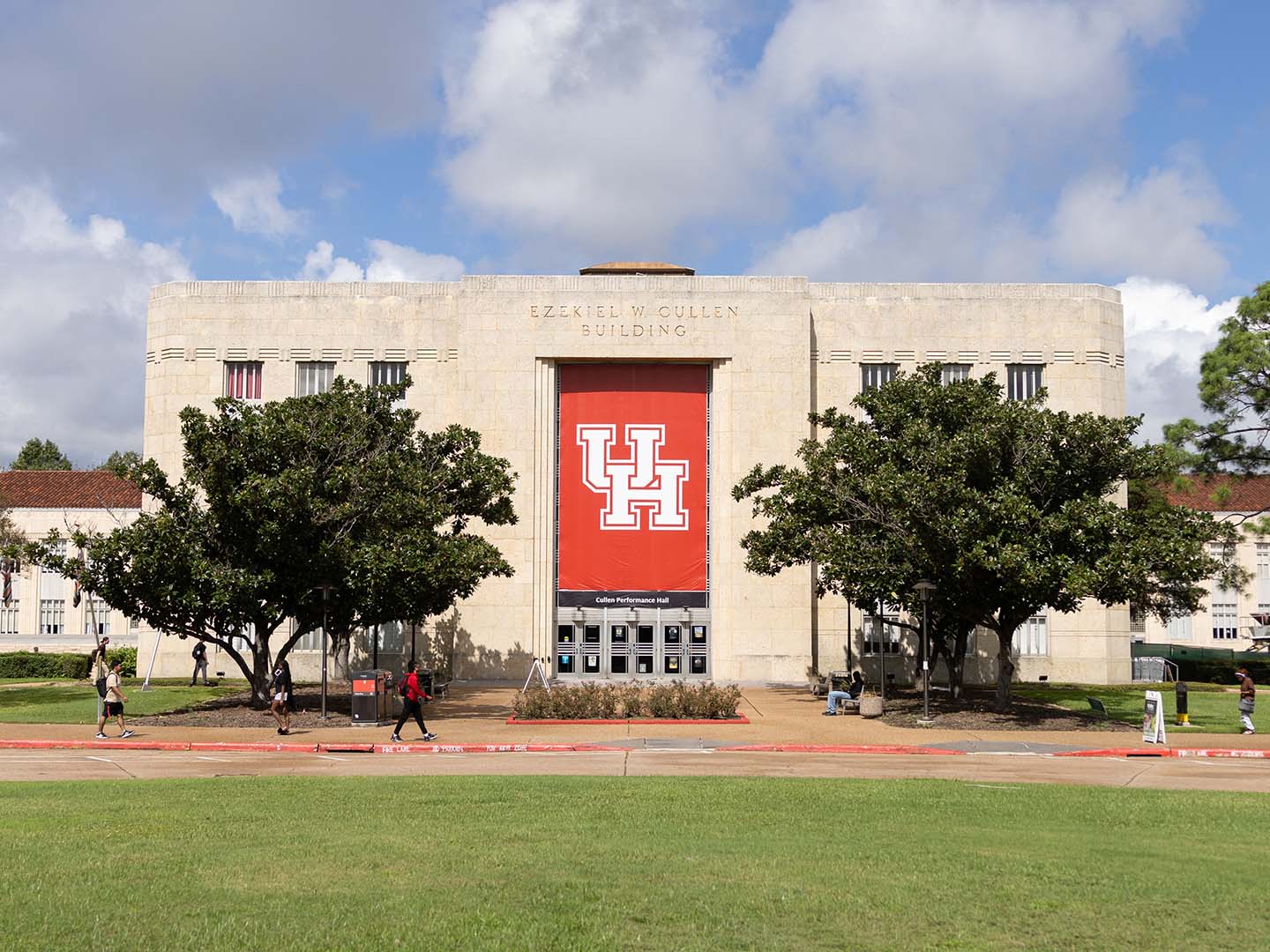 Cullen Performance Hall with large red UH banner on a nice day.