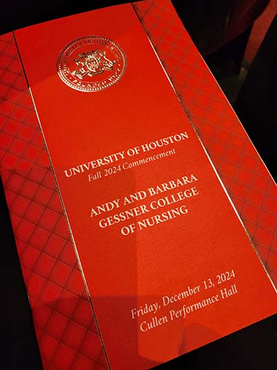 Red front cover of an event program. The words "University of Houston Fall 2024 Commencement. Andy and Barbara Gessner College of Nursing" appear on the cover in gold letters.